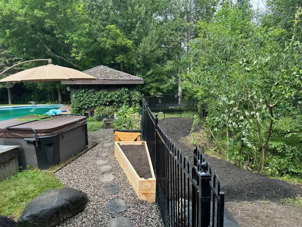 Margaret's Barrhaven property after complete cleanup revealing clean garden beds and open space