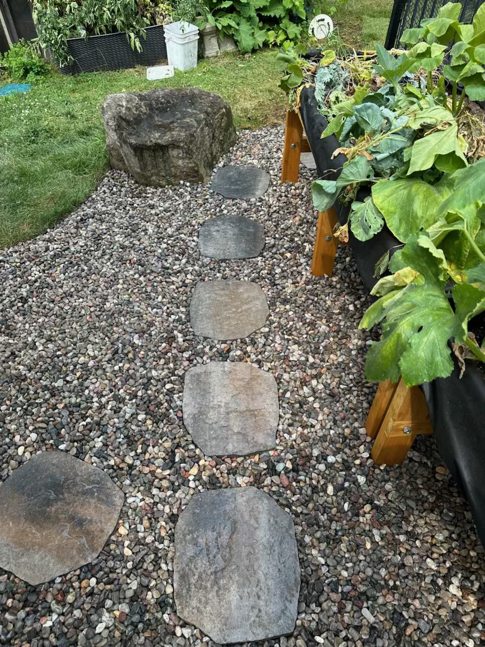 Another cleared area of the Barrhaven property showing defined garden beds and restored pathways