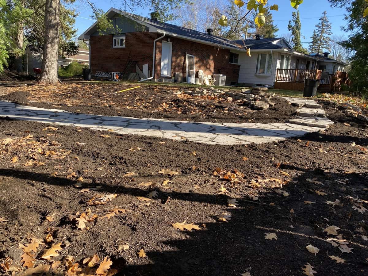 Natural flagstone pathway under construction in Nepean garden with stones being carefully placed and leveled