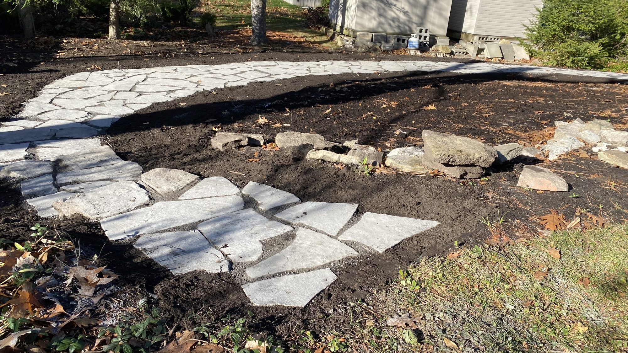 Close view of accessible flagstone pathway taking shape through restored Nepean garden
