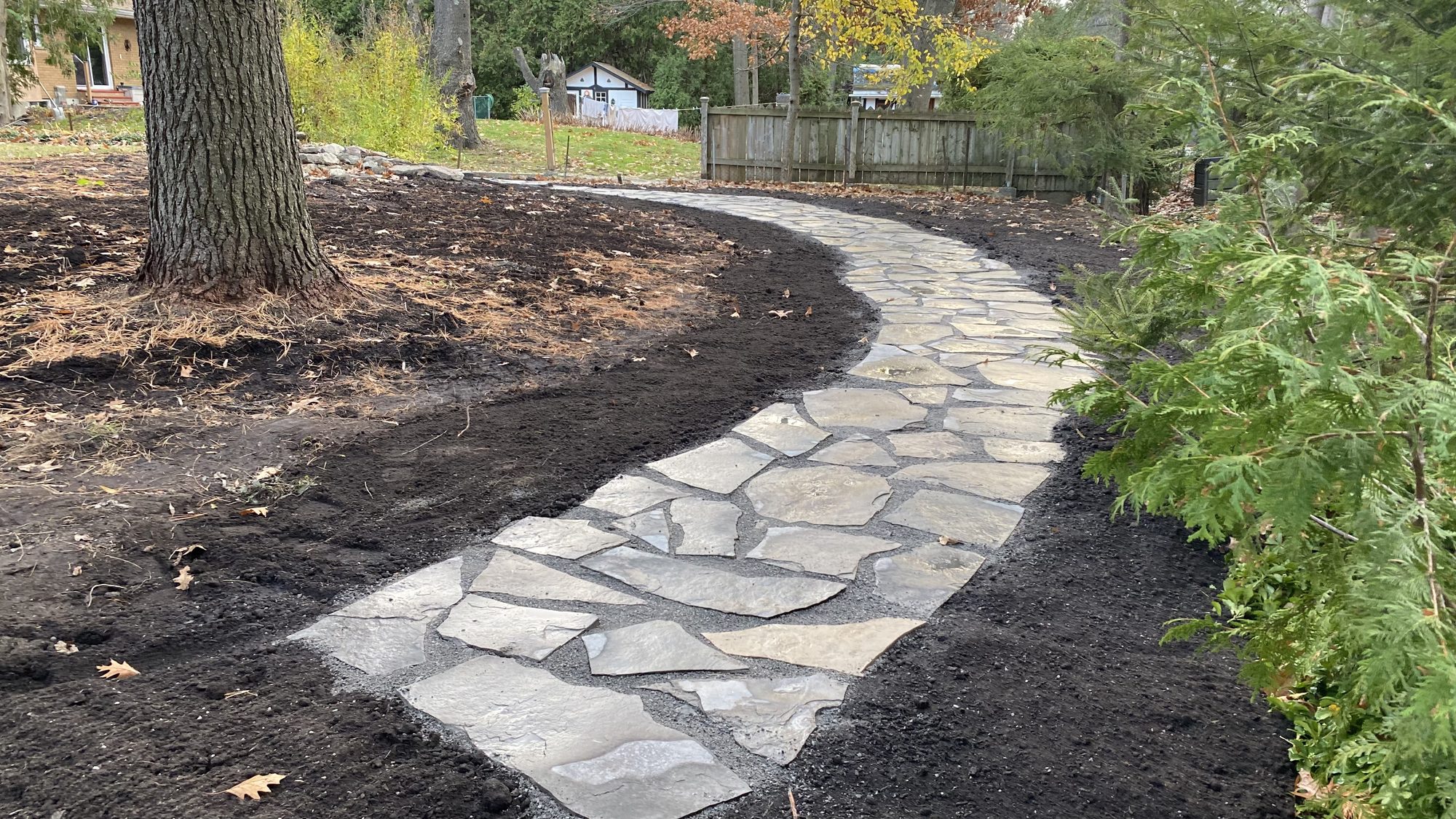 Precision flagstone placement ensuring long-term pathway stability for accessible garden navigation