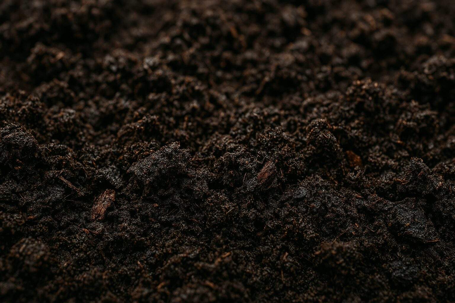 Close up of dark, crumbly, amended garden soil