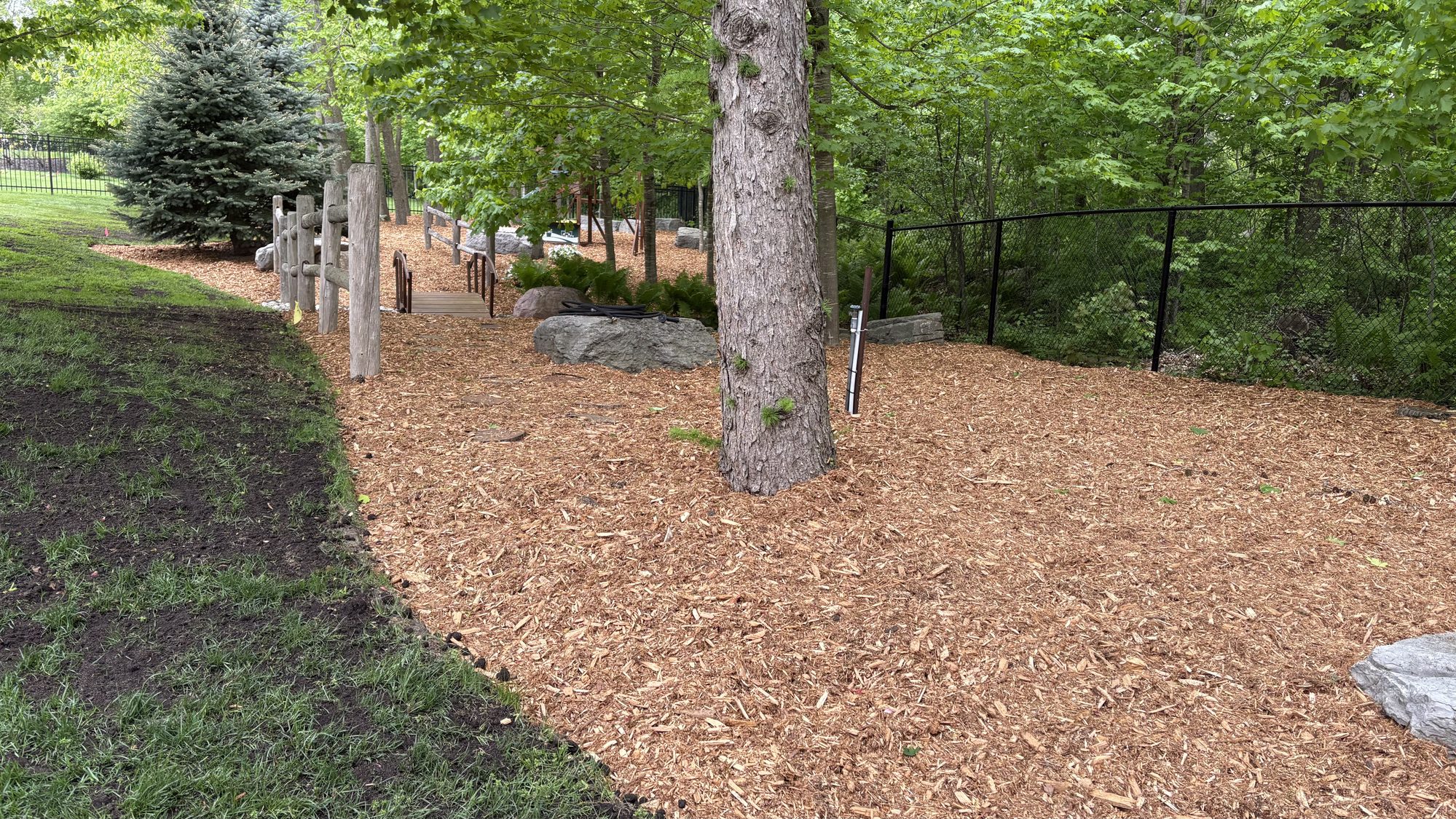 Fresh mulch installation with clean garden bed borders in Ottawa